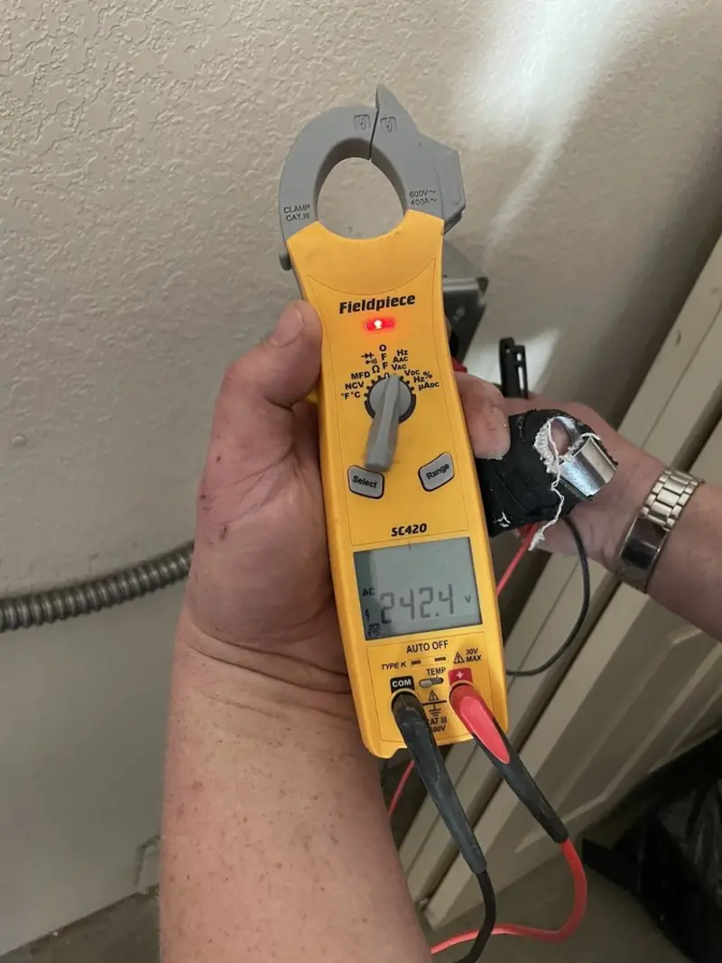 Voltage testing with clamp meter during Outlet Installation in Chelsea